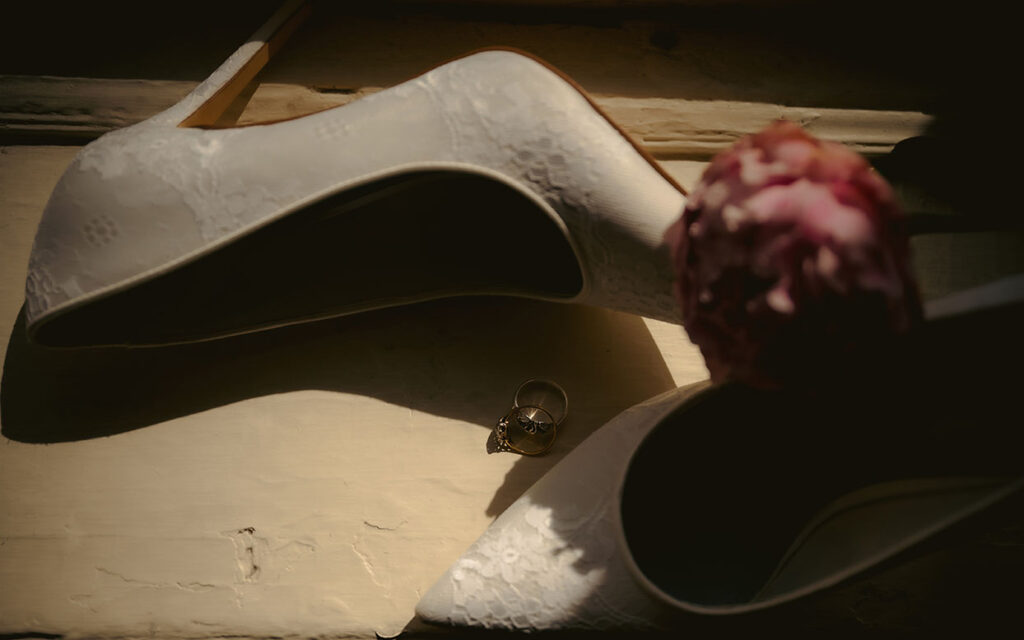 Bridal shoes with flower and ring at the Mansion on 5th