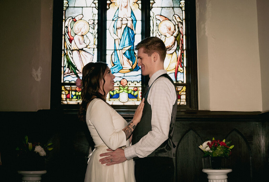 Couple Face each other at the chapel of Mansion on fifth.