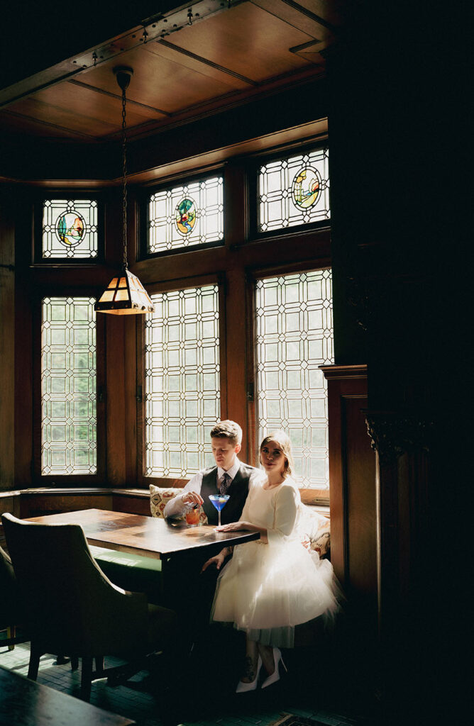 Bride and Groom sitting at Mansion on fifth