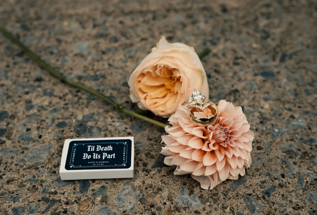 Detail photo of engagement ring and wedding band with flowers