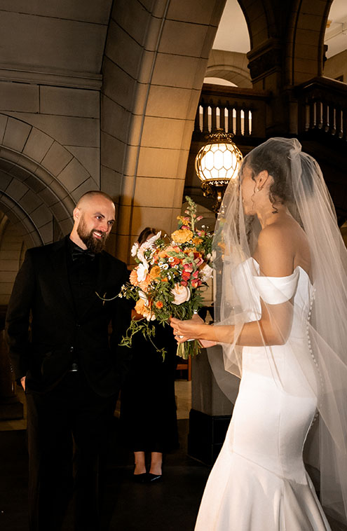 Bride and groom exchanging vows inside the Allegheny County Courthouse surrounded by family during their Pittsburgh elopement.