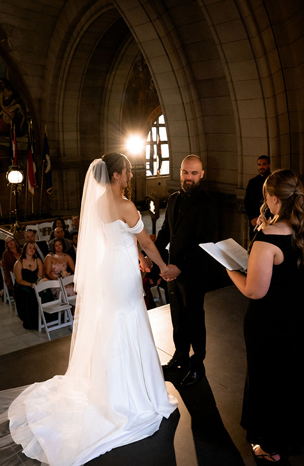 Bride and groom exchanging vows inside the Allegheny County Courthouse surrounded by family during their Pittsburgh elopement.