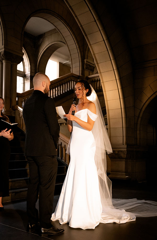 Bride and groom exchanging vows inside the Allegheny County Courthouse surrounded by family during their Pittsburgh elopement.