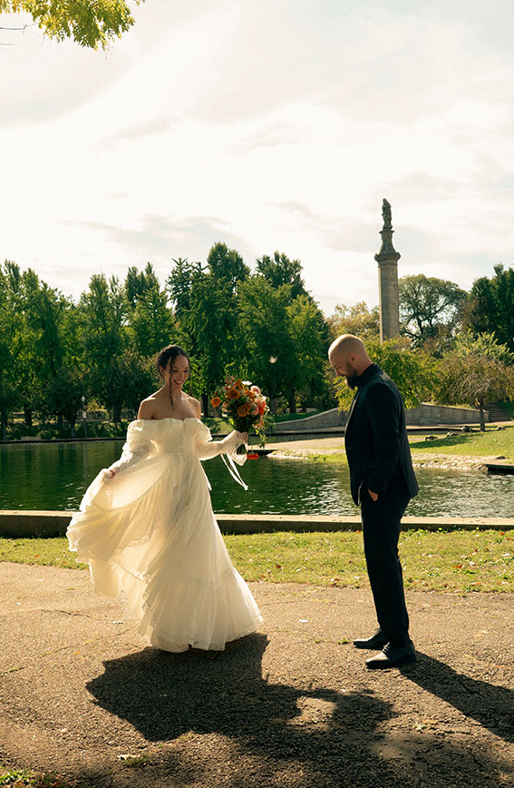 Bride and groom laughing together during their wedding portraits at Allegheny Commons Park in Pittsburgh, captured by Natalia Baqueiro Photography.