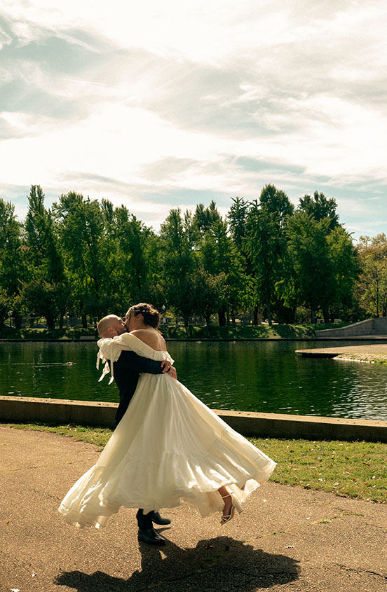 Bride and groom laughing together during their wedding portraits at Allegheny Commons Park in Pittsburgh, captured by Natalia Baqueiro Photography.