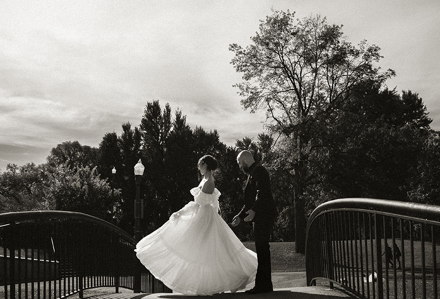 Newlyweds walking through Allegheny Commons Park after their Pittsburgh courthouse elopement, surrounded by fall trees and golden light