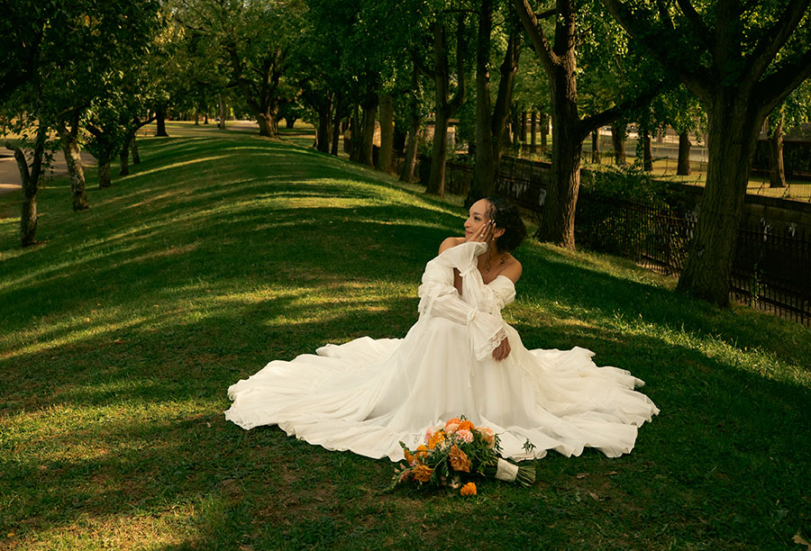 Bride Sitting in Allegheny Commons Park after their Pittsburgh courthouse elopement, surrounded by trees