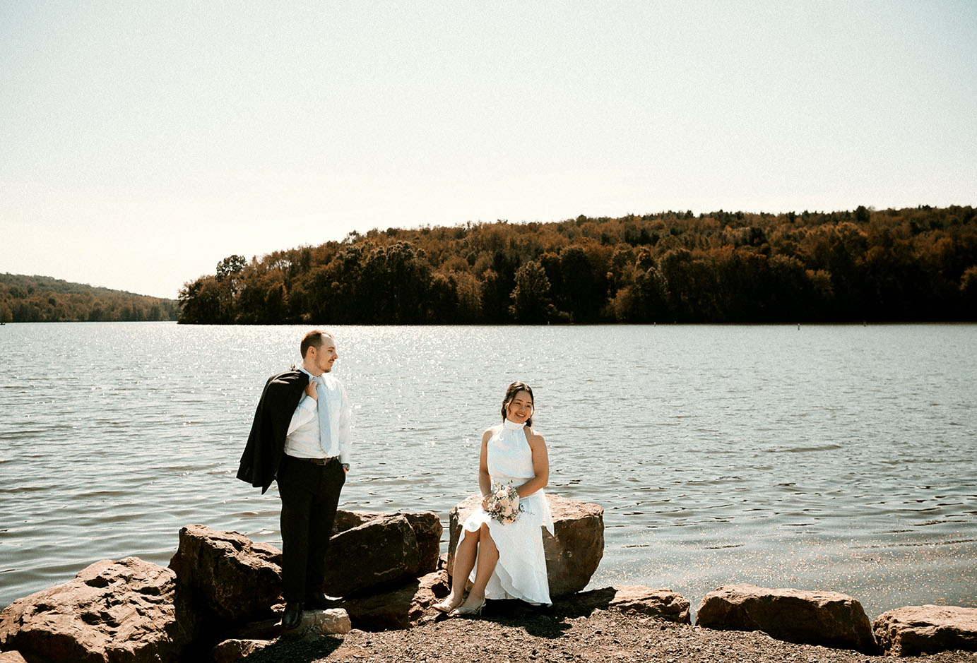 Moraine State Park Bride and Groom Sitting by the water