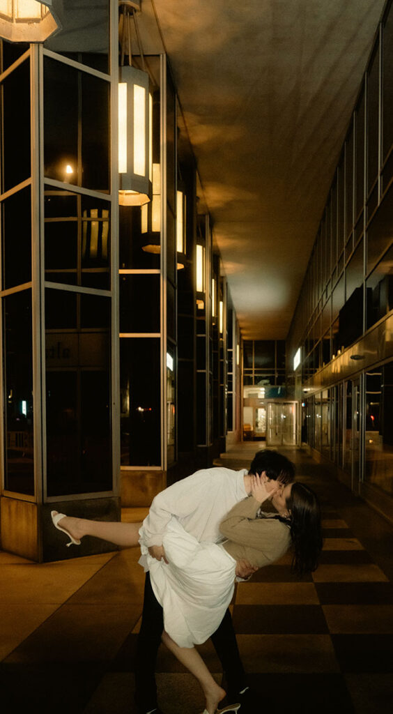 Documentary-style photo of a couple laughing under Market Square lights in Pittsburgh.