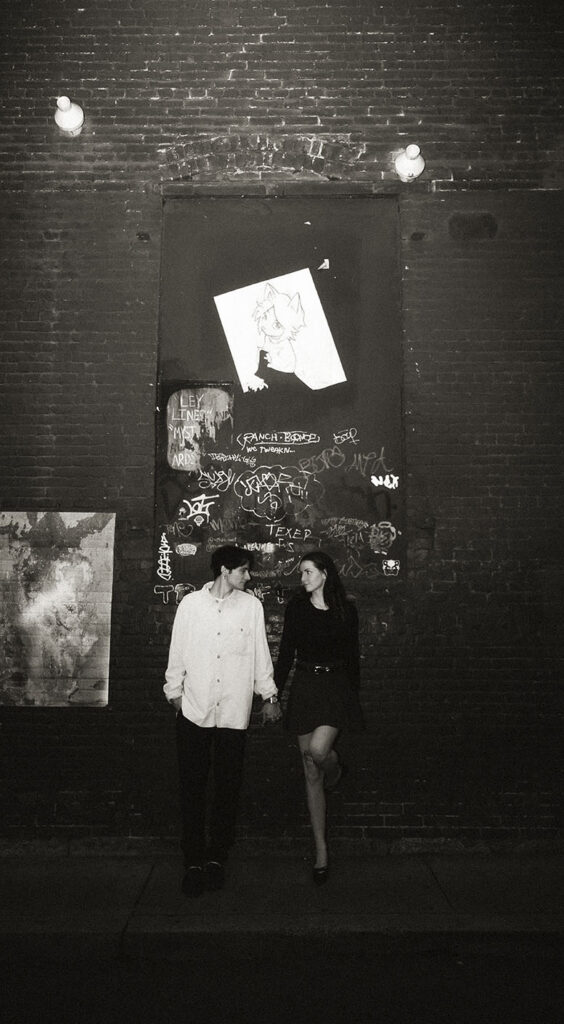 Cinematic street photo of a couple embracing under Pittsburgh street lights.