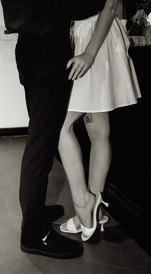 Couple embracing each other showing off engagement ring