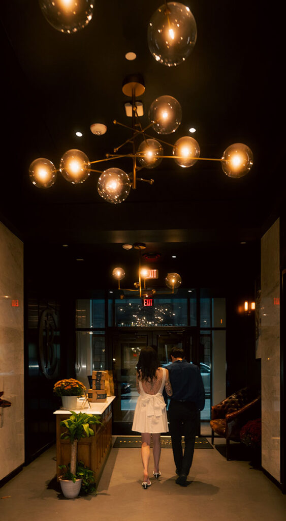 Documentary-style photo of a couple Walking out of Downtown Pittsburgh Building