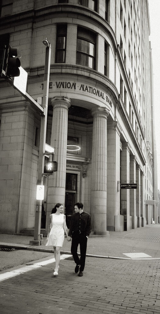 Couple walking hand in hand down in Downtown Pittsburgh