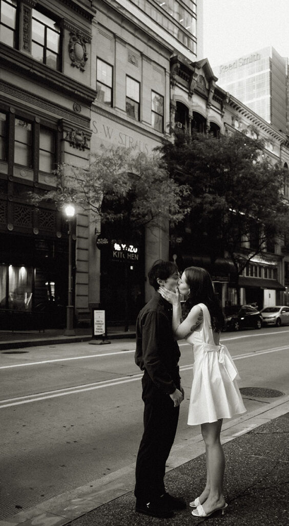 Documentary-style photo of a couple Kissing in Downtown Pittsburgh