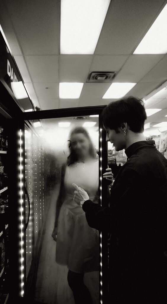 Couple sharing a playful moment inside the 7-Eleven in Downtown Pittsburgh.