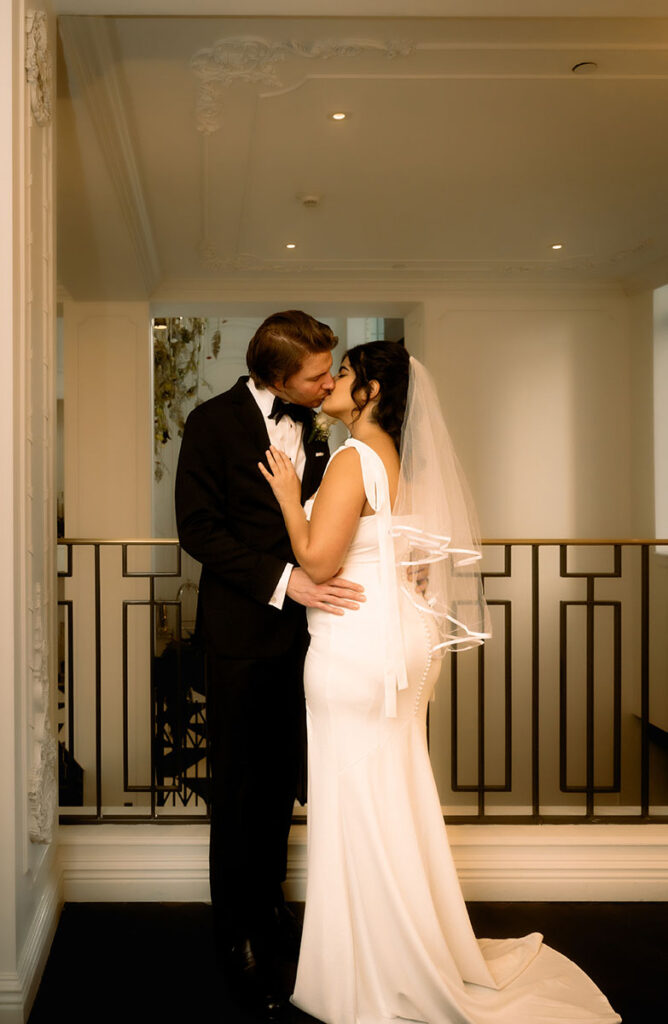 Bride and groom embrace and kiss at the Kimpton Hotel Monaco before their courthouse elopement.