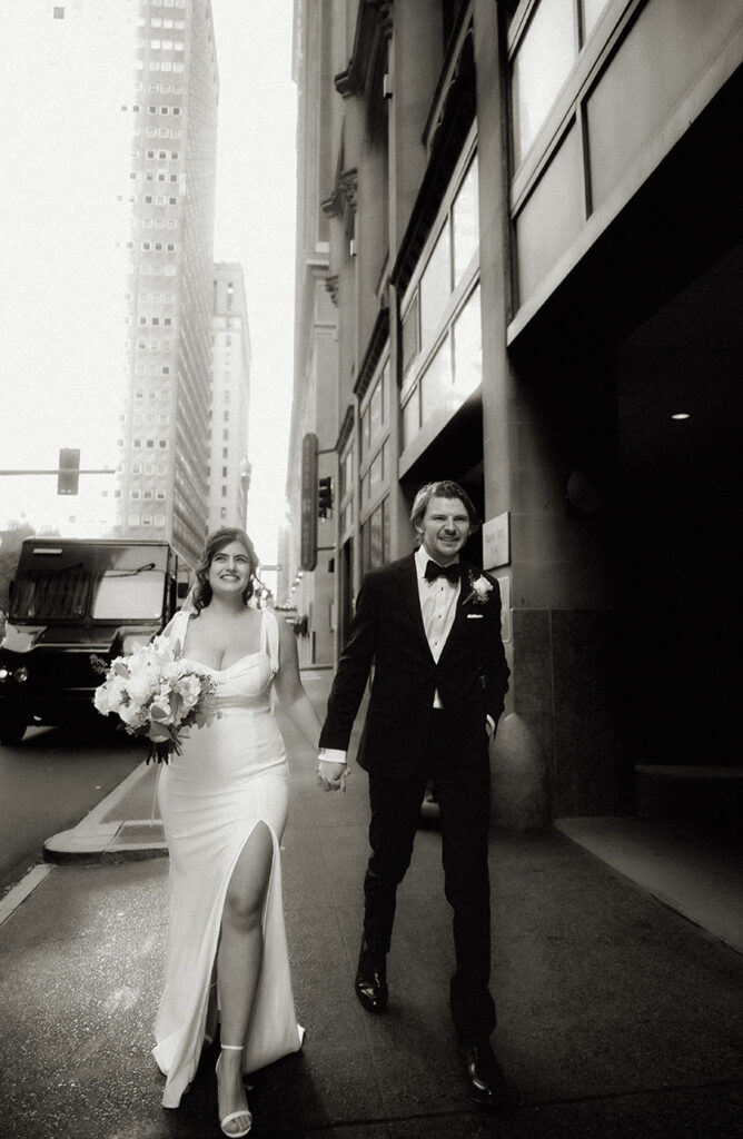 Candid editorial-style couple walking through Downtown Pittsburgh on their elopement day.