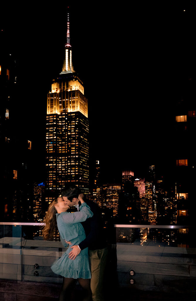Documentary engagement photos in New York City of a couple on their apartment rooftop at sunset, photographed in an editorial style.