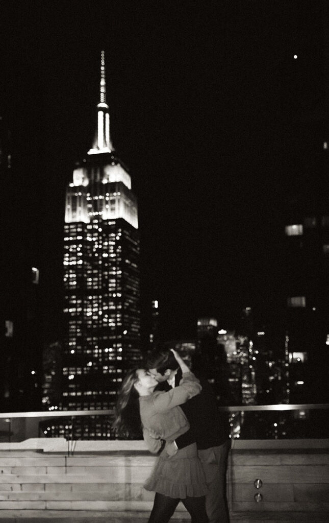 Couple sharing an intimate moment on their apartment rooftop at 10 E 29th Street in New York City during a documentary engagement session.