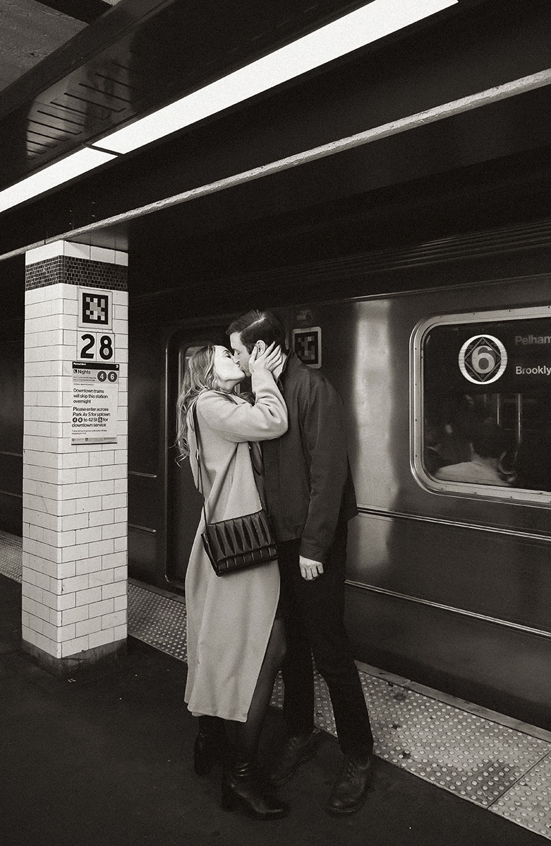 Documentary engagement photos of a couple riding the NYC subway, capturing real movement and connection.