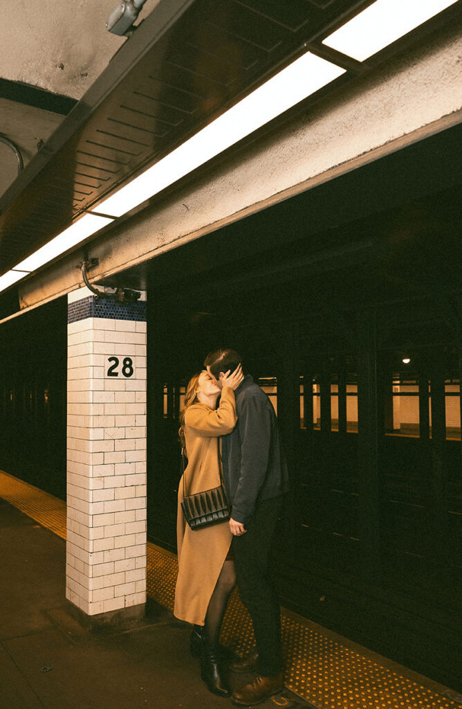 Editorial couple photography in the New York City subway with cinematic lighting and authentic moments.