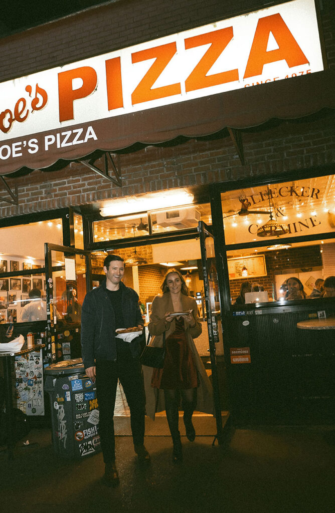 New York City couple photography at Joe’s Pizza, capturing laughter and real moments during an evening session.