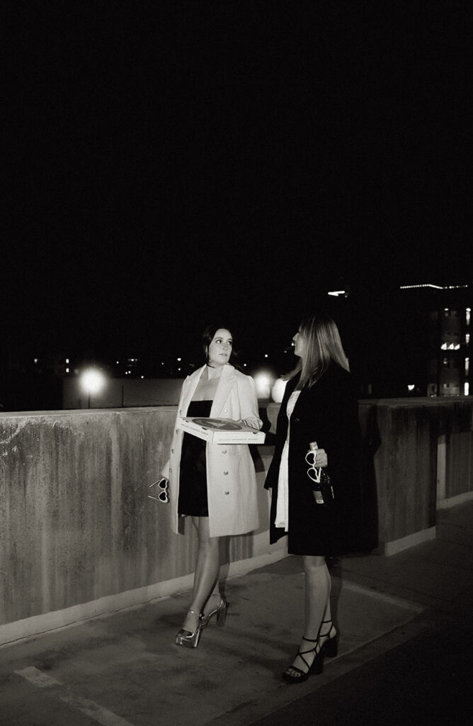 Paparazzi-style couple photo walking through the streets of Downtown Pittsburgh at golden hour
