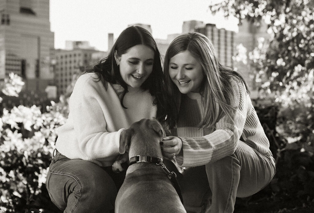 Couple taking sunset photos in Downtown Pittsburgh with their dog during a documentary-style session