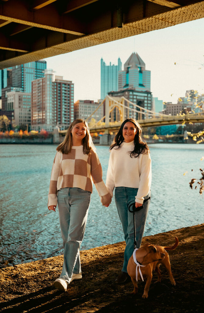 Couple taking sunset photos in Downtown Pittsburgh with their dog during a documentary-style session.