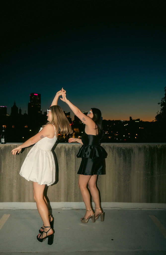 Editorial nighttime photo of couple dancing on a rooftop in the Strip District.
