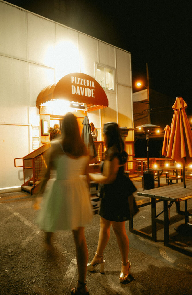 Fun candid photo of couple eating pizza at Pizzeria Davide in the Strip District