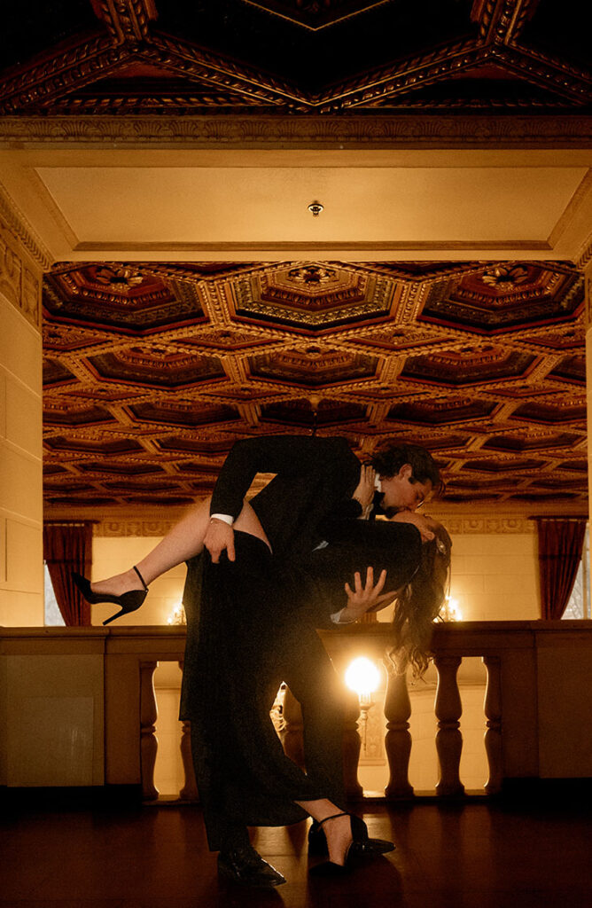 Couple sharing a private first look beneath an artistic ceiling in Downtown Pittsburgh