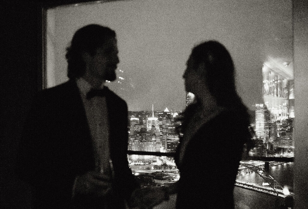 Romantic nighttime wedding portraits with Pittsburgh skyline at Monterey Bay