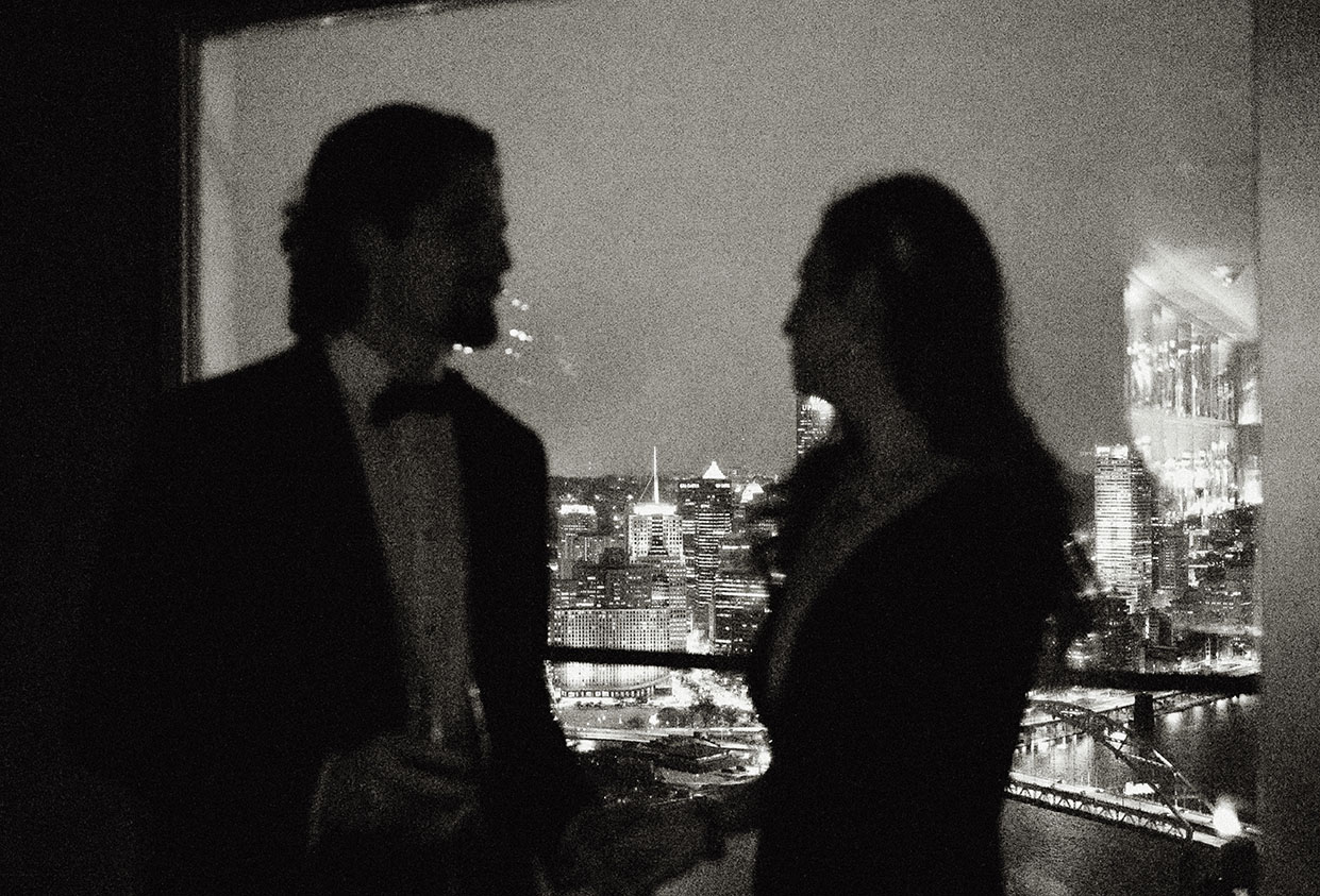 Romantic nighttime wedding portraits with Pittsburgh skyline at Monterey Bay