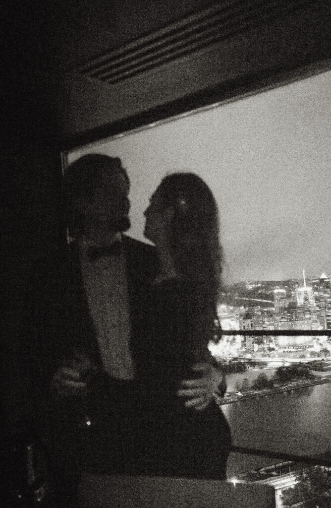 Nighttime wedding portraits with city skyline in Pittsburgh