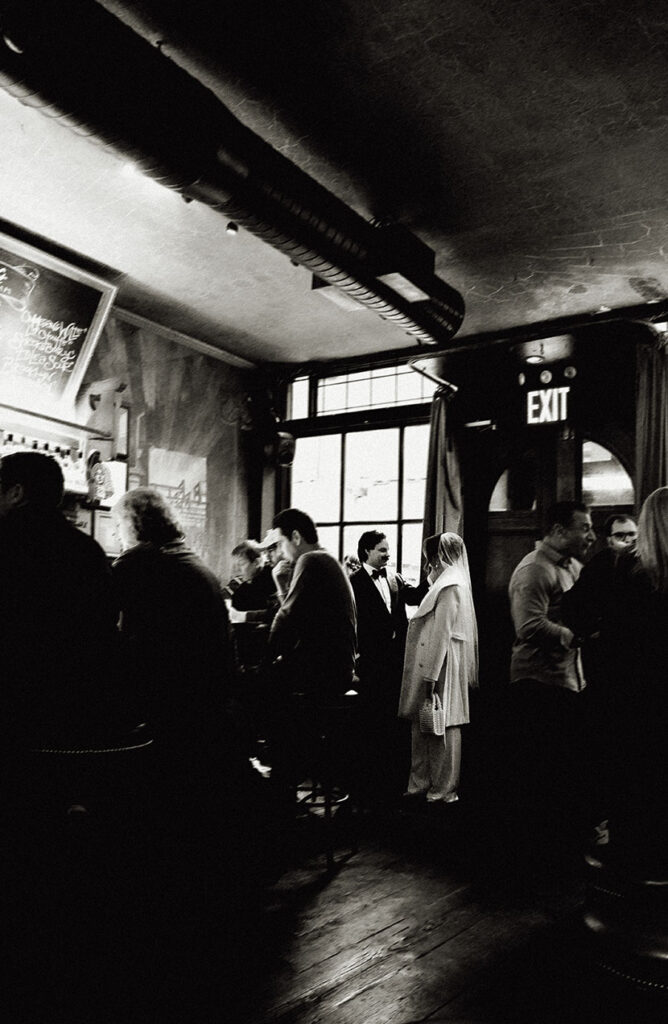 Couple wait for a drink at Swift Bar in NYC after their elopement