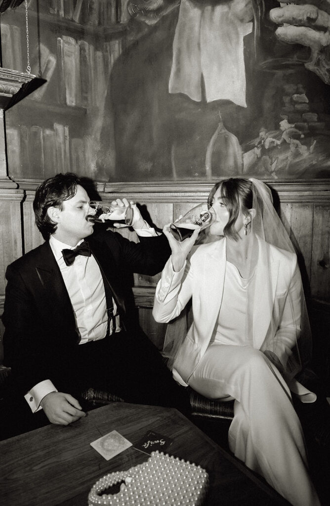 Bride and Groom drink a beer at Swift Bar in NYC after their intimate wedding.