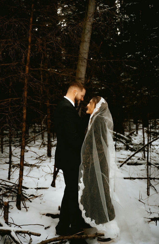 Newlyweds embracing at Skytop Lodge Pennsylvania during cozy winter wedding