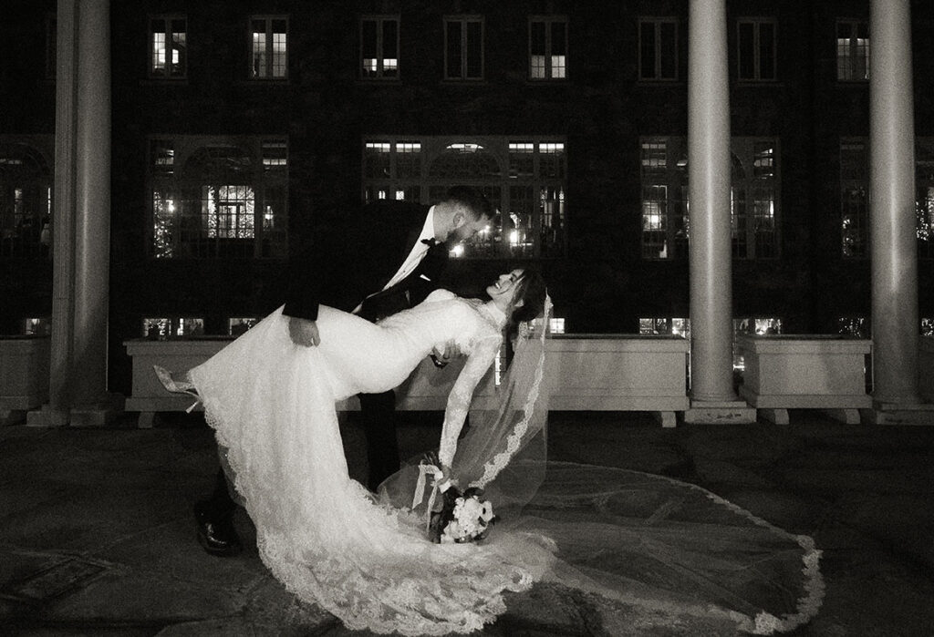 Editorial wedding portrait of bride walking through mountain lodge grounds