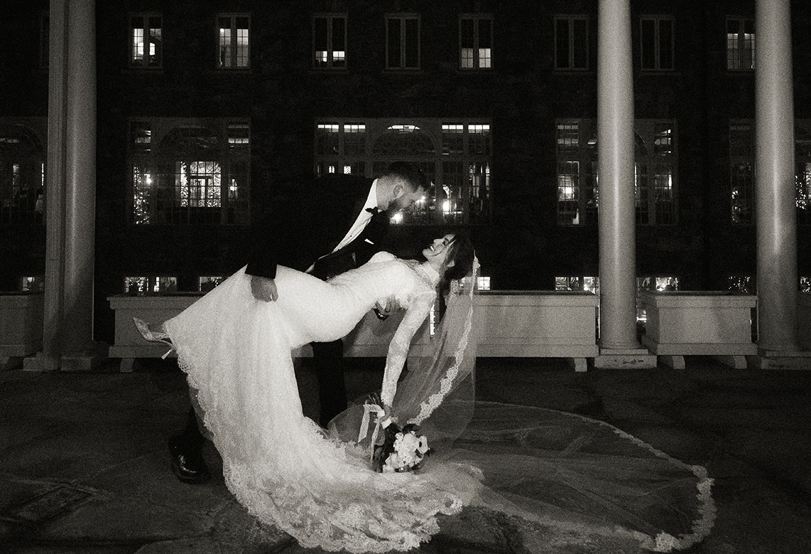 Editorial wedding portrait of bride walking through mountain lodge grounds