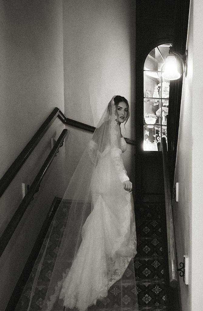 Bride walking up with a vintage BW look shot in an editorial way by Natalia Baqueiro