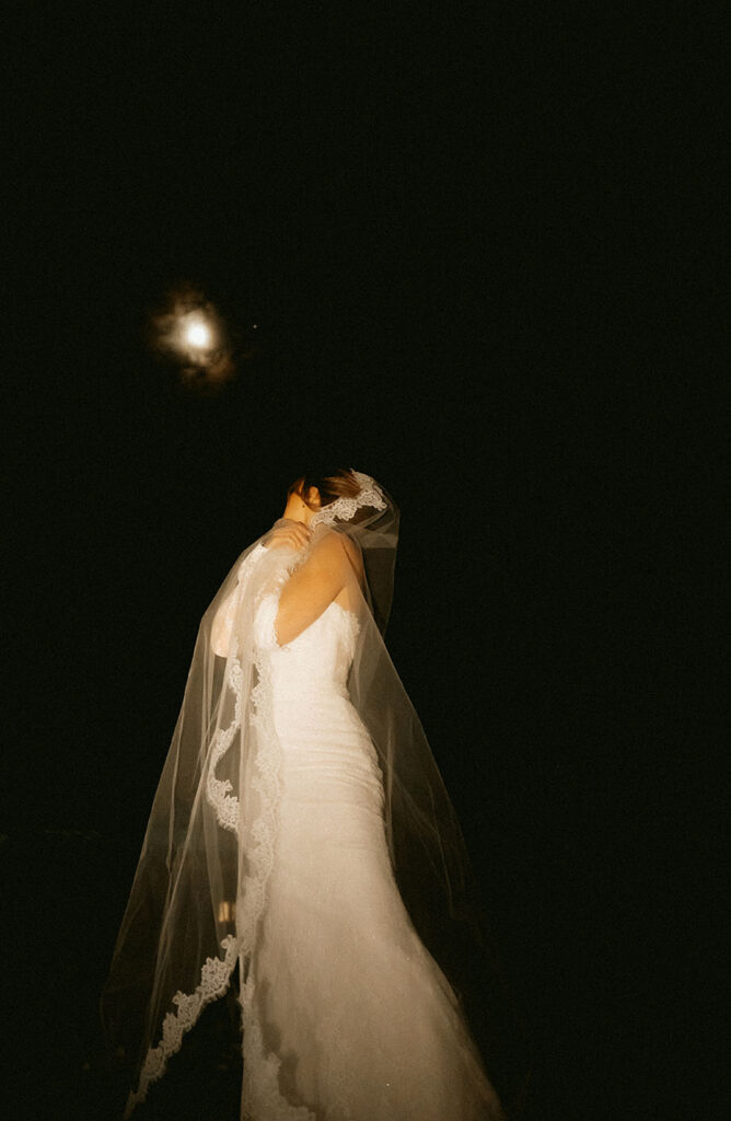 Artistic winter wedding photo featuring moonlight and mountain scenery
