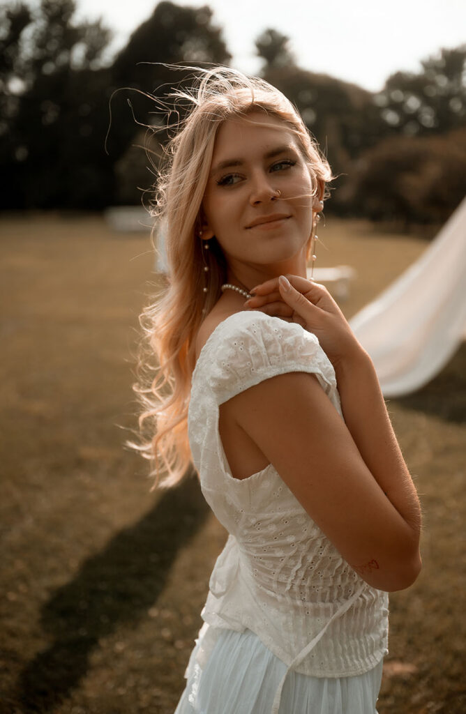 Woman touches her shoulder during engagement session in Pittsburgh