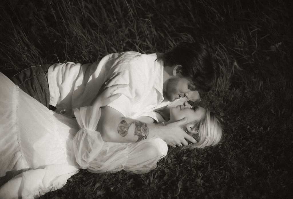 BW Couple looking at each other during summer engagement photo in Pittsburgh.
