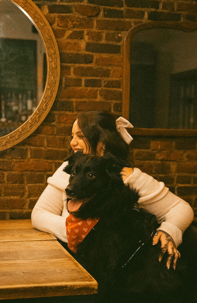 Romantic Pittsburgh engagement portrait with couple holding their dog in meaningful South Side location