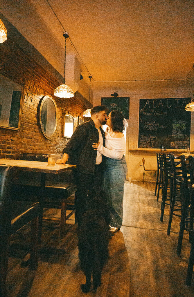 Couple kiss at Acacia Bar in the South Side in Pittsburgh.