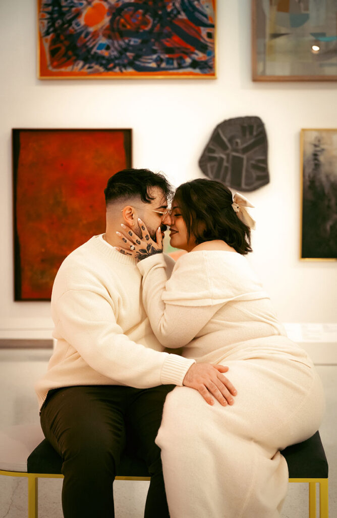 Elegant museum engagement photo in Pittsburgh with couple surrounded by paintings and refined gallery architecture