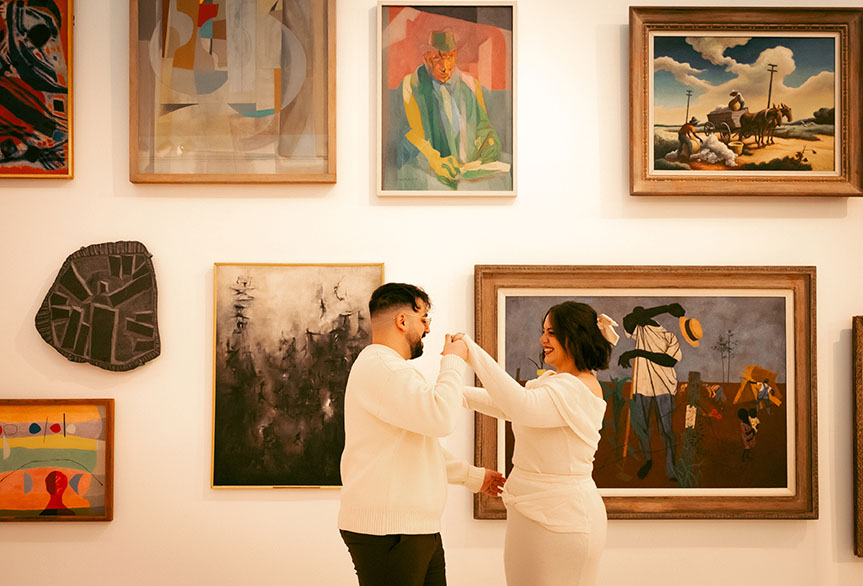 Couple photographed in front of paintings at Carnegie Museum of Art creating a timeless editorial engagement look in Pittsburgh