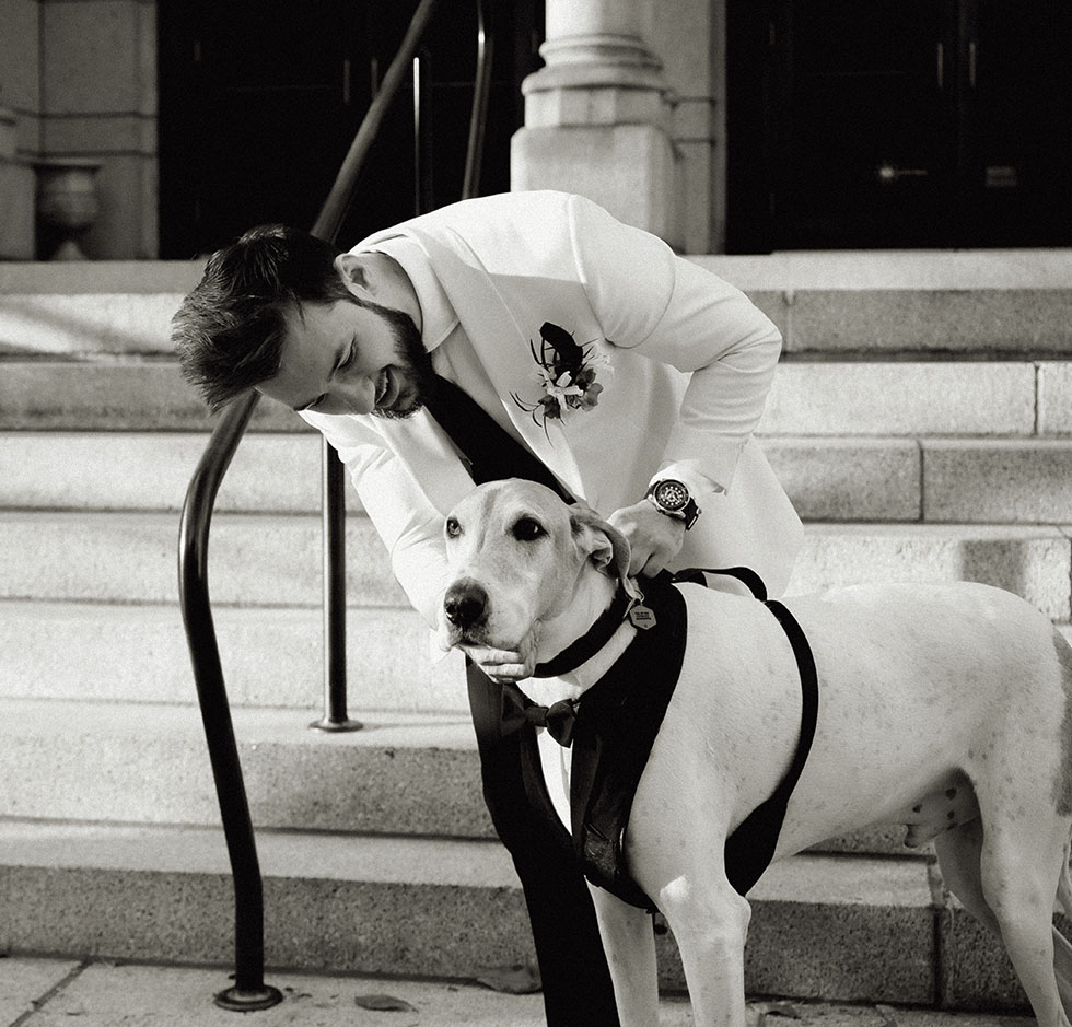 Groom with his dog wearing a tux at his wedding in Pittsburgh