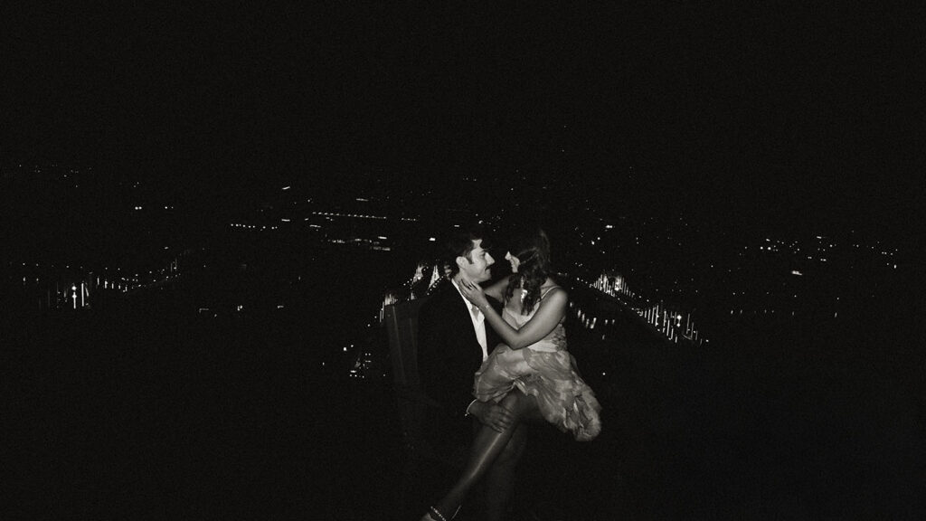 Rooftop engagement photos overlooking Pittsburgh skyline at night
